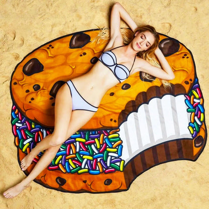 Woman lying on a large cream filled cookie on sand