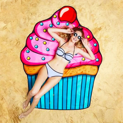 Woman lying on a colorful cupcake-shaped towel on a sandy background