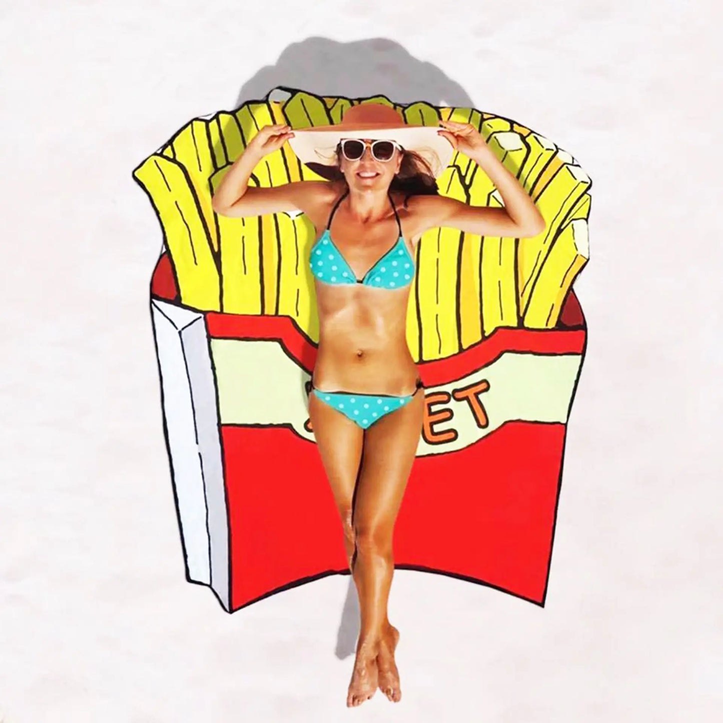 Woman in a bikini sitting on a colorful French fry-shaped beach towel.