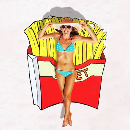 Woman in a bikini sitting on a colorful French fry-shaped beach towel.