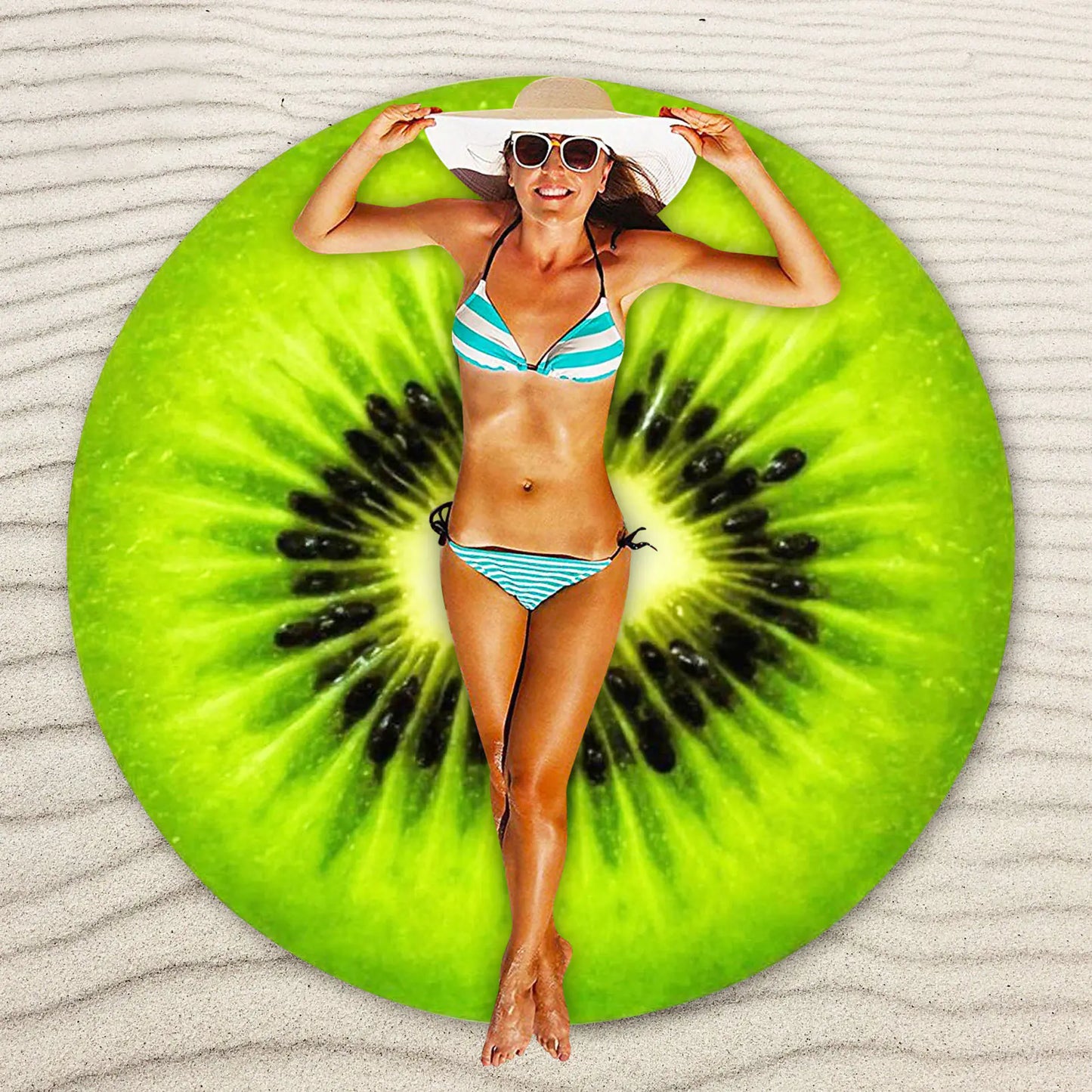 Woman in a bikini lying on a kiwi fruit-shaped beach mat.