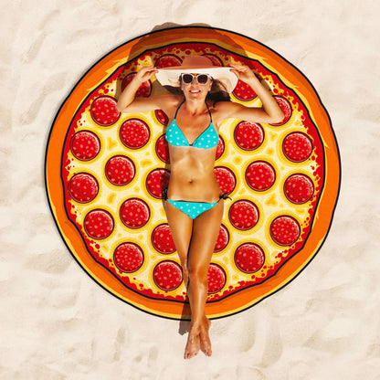 Woman lying on a pizza-themed beach towel on sand