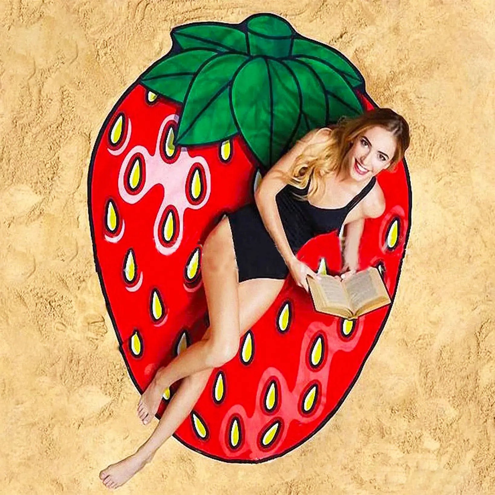 Woman sitting on a strawberry-shaped pool float on a sandy beach