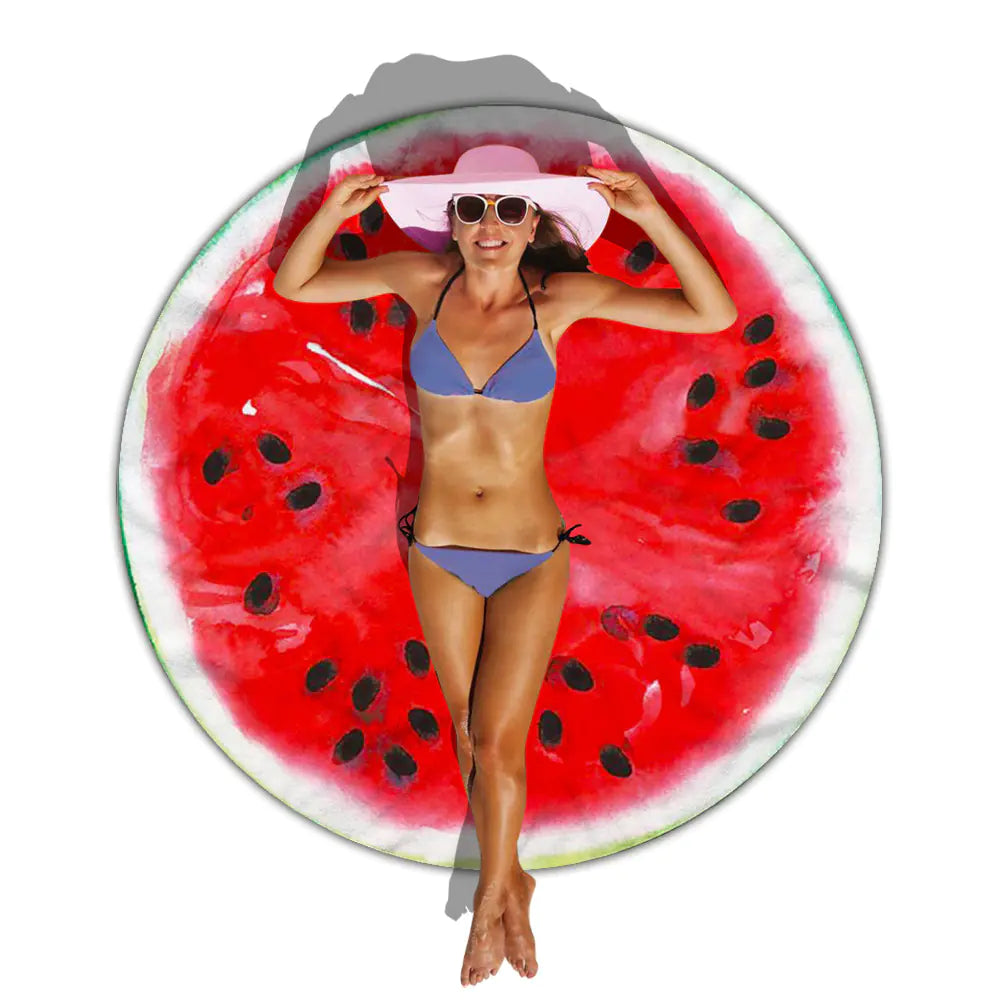 Woman lying on a watermelon-patterned towel.